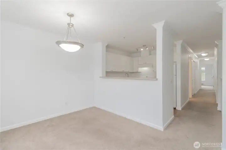 Dining area with a view down the hallway to the bedrooms and utility area.