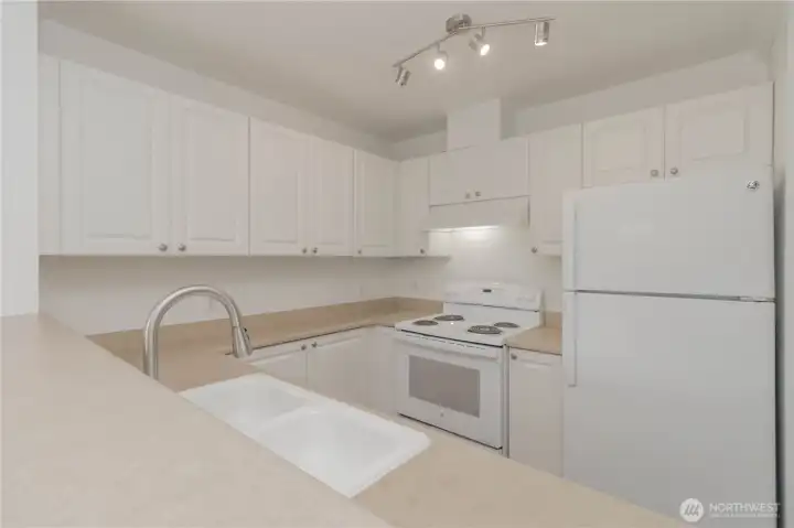 Kitchen offers abundant cabinetry and generous counter space.