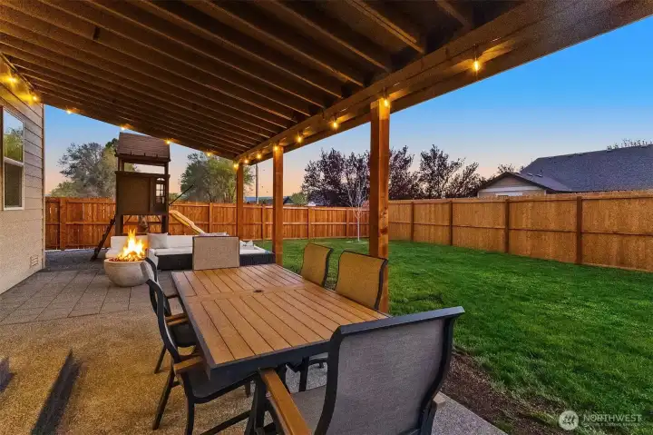 Covered Outdoor Living Area with private, fully fenced Backyard
