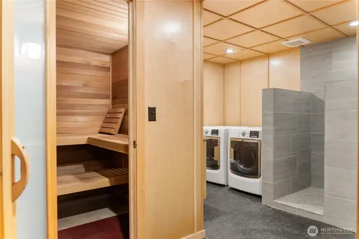 Exceptional lower-level amenities include a plush wood sauna, spa-inspired tiled walk-in shower, and thoughtfully designed laundry area, creating the perfect four-season retreat after skiing, hiking, biking, or outdoor adventures. The expansive utility and storage areas (not pictured) offer oversized shop space, extra refrigerator/freezer capacity, utility sinks, organized storage closets, ski and gear storage, plus flexible staging space for entertaining, backyard BBQs, and gathering with family and friends.