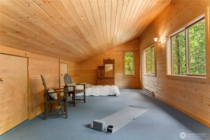 Finished upper-level space above the detached garage with warm wood finishes, vaulted ceilings, natural light, and extra storage tucked into the eaves for all the treasures and gear that come with mountain living. Ideal for guest overflow, bunk room, studio, home office, recreation space, or private retreat.