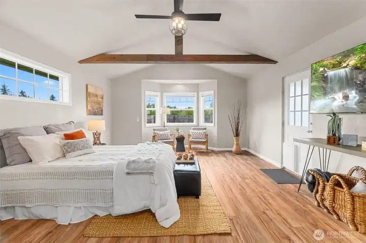 Primary bedroom with vaulted ceilings.