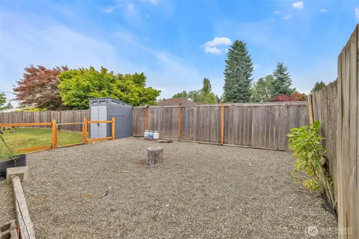 Separate gated area in backyard, perfect for garden, pets, or firepit area.