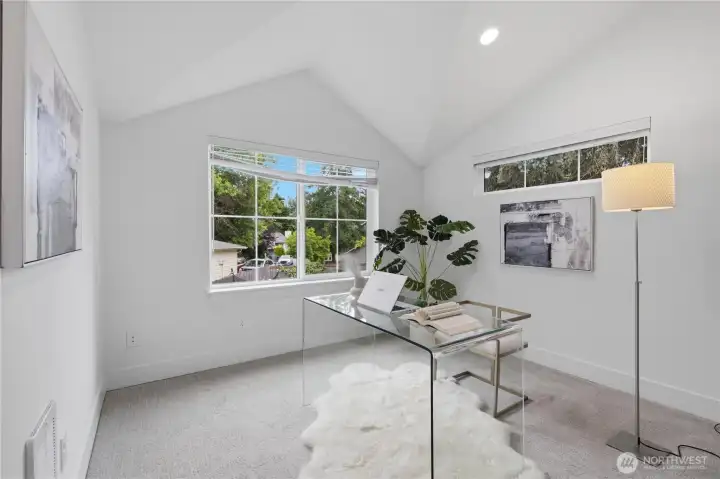 One of the two guest bedrooms on upper level; Staged as office. One of the two guest bedrooms on upper level; Staged as office.
