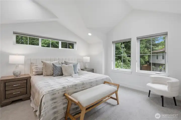 Primary bedroom on upper level with vaulted ceiling. Primary bedroom on upper level with vaulted ceiling.