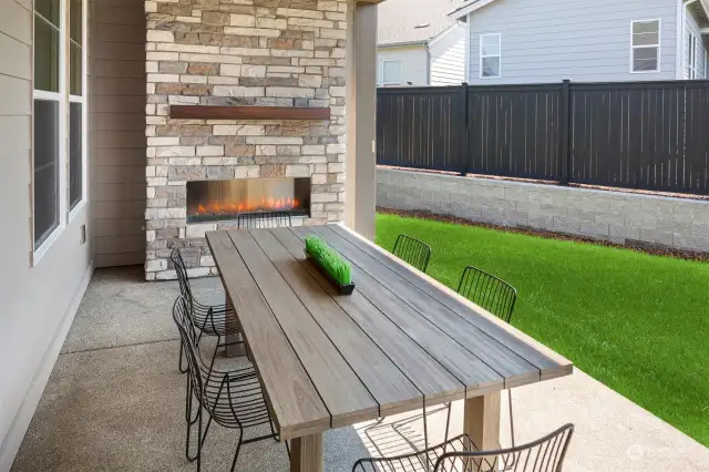 Large covered patio with outdoor gas fireplace and fully fence backyard