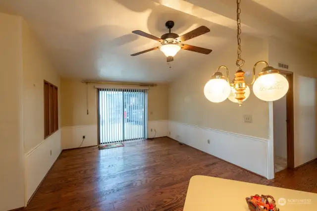 Family room with ceiling fan and slider to driveway/garage