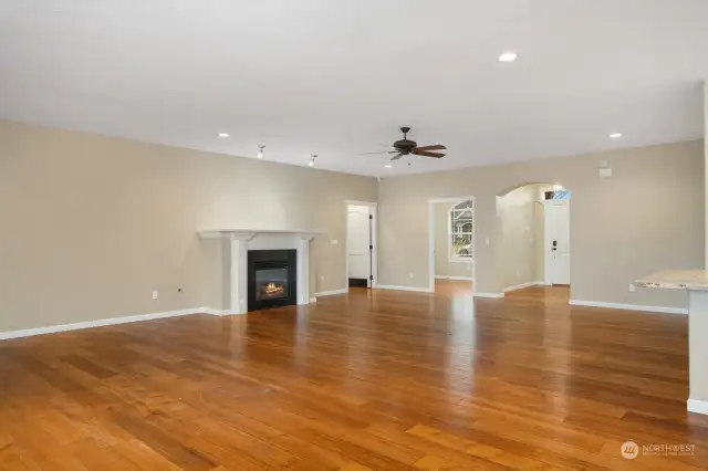 Great room looking back toward entry hall and entry to office/den and Primary Bedroom