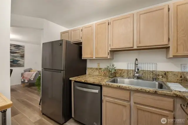 Update kitchen with granite countertops opens to the living and dining area