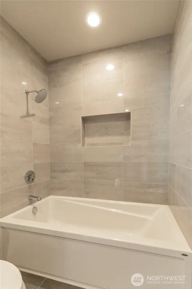 Large tub in hallway guest bath