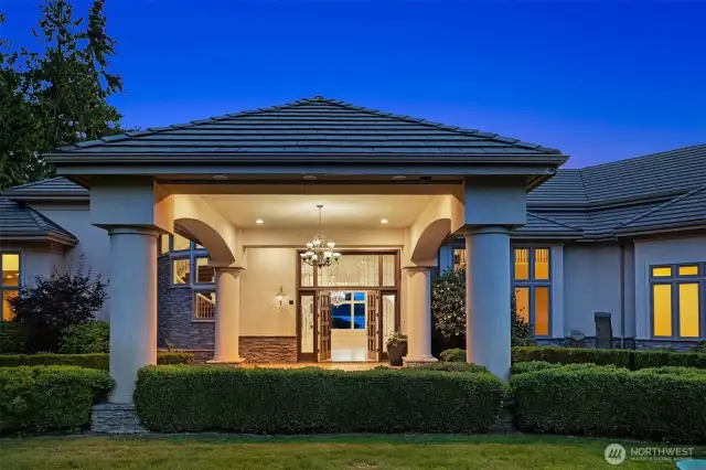 Porte Cochère from circular driveway to Double entry wood doors framed by elegant custom glass by Doug Fillbach (2001).