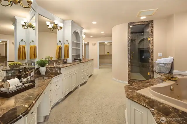 Primary Bath with large jetted whirlpool InfinityBath, walk-in shower w/bench, double vanity w/sitting area, and spacious walk-in California closets.