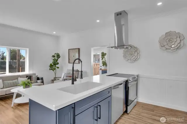 Great view from the kitchen sink of the living room and through the laundry room to the back door