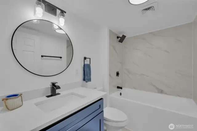 Bathroom off the laundry room with extra deep tub and new tile!