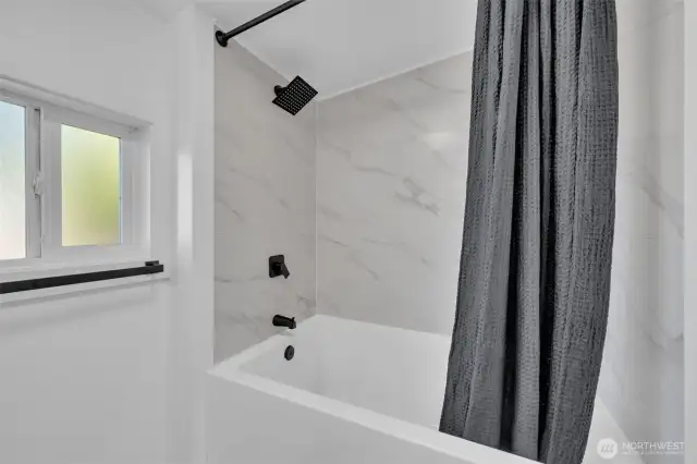Primary bathroom with its own deep tub and new tile!