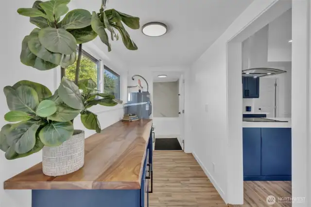 Laundry room off the living area with access to the bathroom and the backdoor