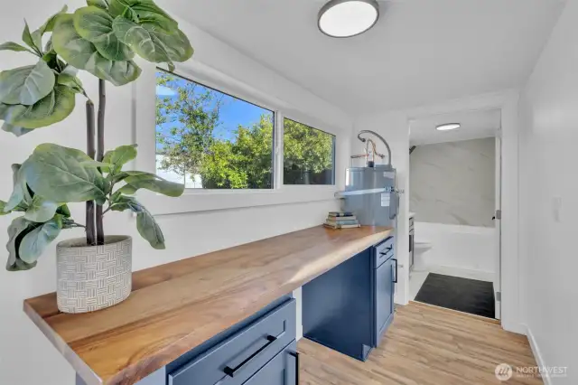 Beautiful custom wood table top in the laundry room with some extra storage!