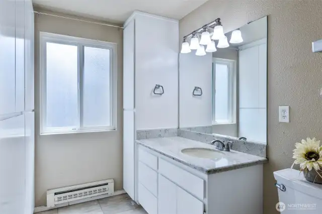 Shower is to the right of the toilet