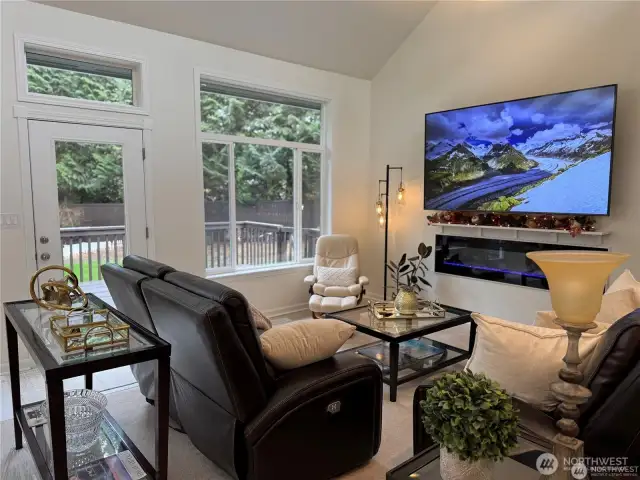 Additional view of the cozy, inviting family room with large windows overlooking serene gardens.