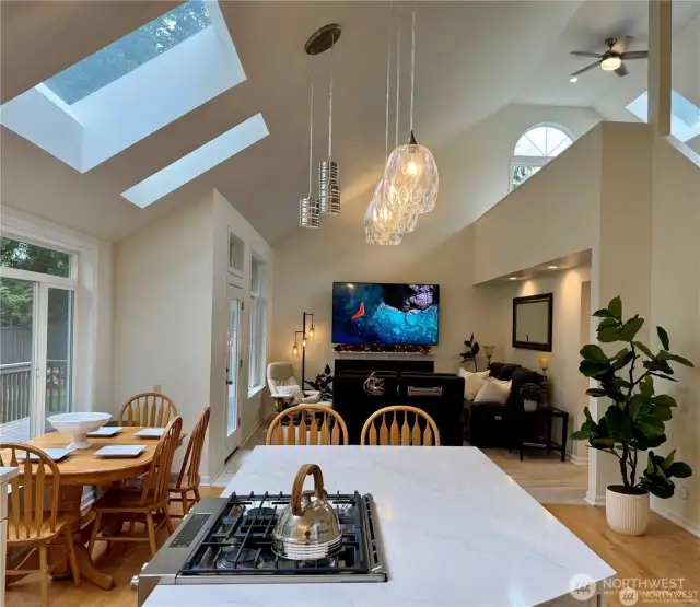 Experience the heart of the home with an open-concept kitchen and family room, where custom skylights and expansive windows flood the space with natural light year round.