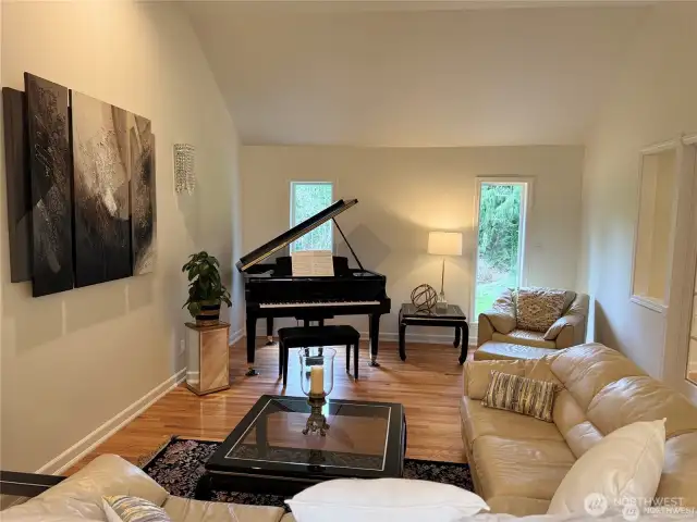 Sophisticated formal living room with classic architectural details, natural light, and a welcoming atmosphere - ideal for entertaining guests or quiet relaxation.