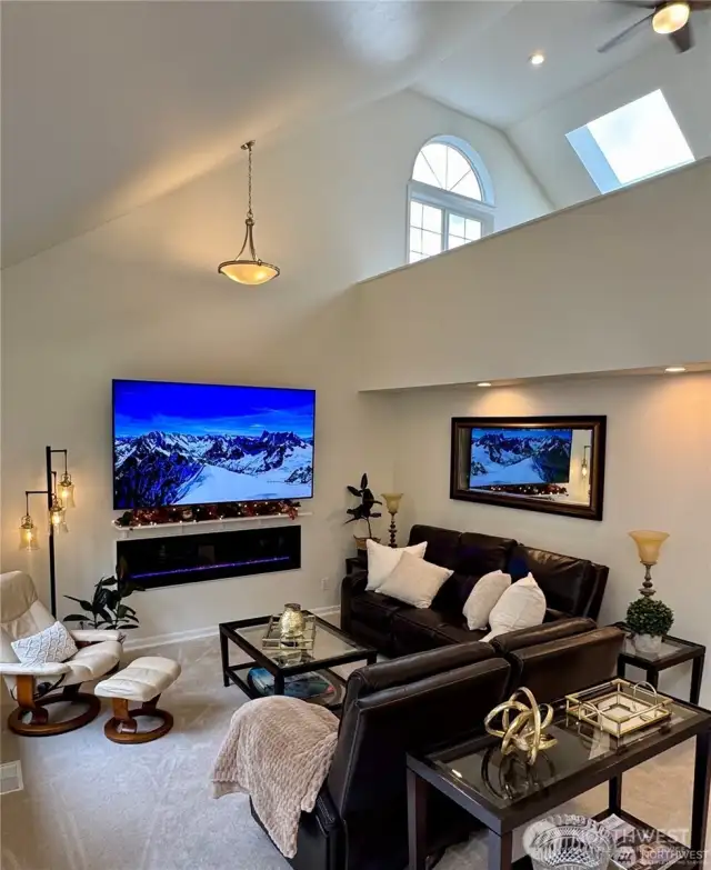 Bright loft featuring two skylights overlooking the family room, offering versatile space perfect for additional office space, hobbies, or a lively playroom for active children.