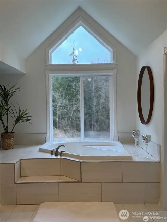Enjoy soaking in the master bedroom en suite jacuzzi tub.