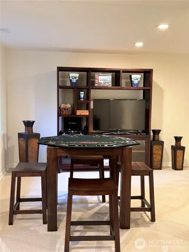 A partial view of the spacious basement designed for entertaining, providing ample room for gatherings, games, and relaxation.