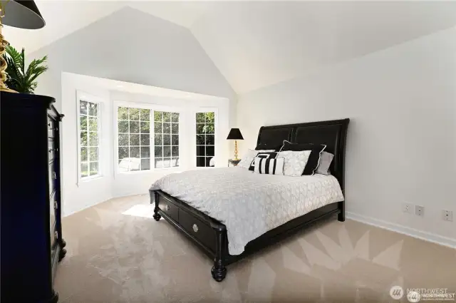 One of four additional bedrooms located on the main level features a charming bay window, adding natural light and architectural interest.