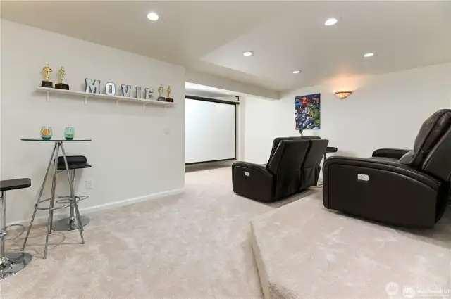 Enjoy an immersive movie experience in the multilevel theatre room, designed with tiered seating for optimal viewing and comfort.