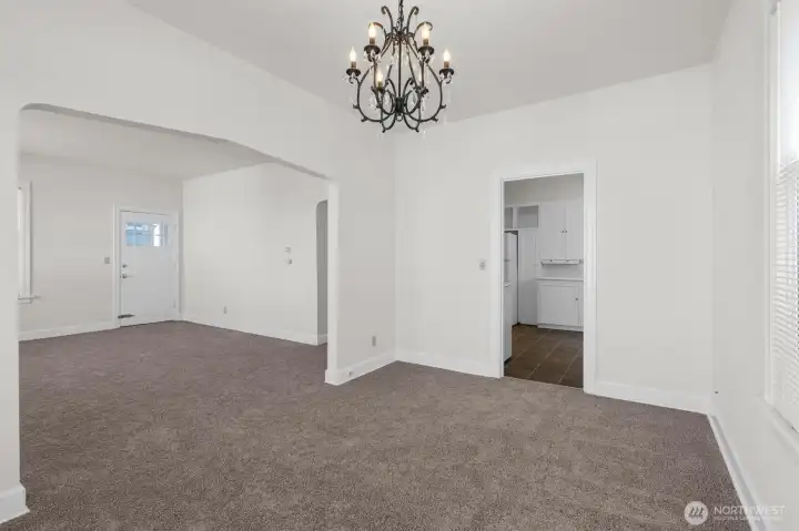 Upper-level dining area with living room to the left and kitchen to the right.