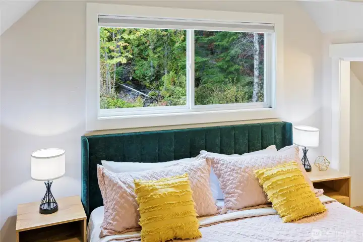 Turner Creek is beautifully framed in the primary bedroom window