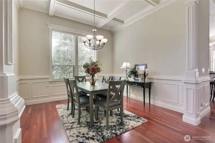This formal dining room is a true showpiece, featuring an elegant tray ceiling that soars to an impressive 18 feet, adding depth and dimension to the space. Intricate architectural details, including beautifully crafted trim and millwork, highlight the home's commitment to quality and custom design. The rich finishes and thoughtful touches reflect a level of care rarely found in today’s homes.