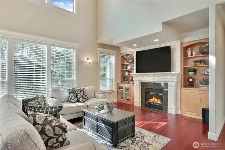 The gathering room is designed for both comfort and style, featuring custom built-ins that elegantly frame the cozy gas fireplace—perfect for showcasing your favorite books, décor, or media. Above, a drop-down theatre ceiling adds a touch of drama and enhances acoustics, creating an immersive atmosphere ideal for movie nights.