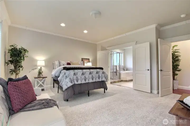 Ooooh la la — the main event is truly the main floor primary suite! This stunning retreat will grab your attention the moment you enter, with its spacious layout and calming ambiance. Large windows invite natural light to dance across the floor, creating a warm and welcoming atmosphere throughout the day. Thoughtfully designed for both luxury and comfort, the suite also offers direct access to the backyard patio through your own private exterior door — perfect for morning coffee or quiet evenings under the stars. It’s a dreamy blend of elegance, privacy, and indoor-outdoor living.