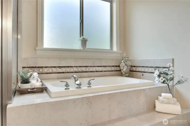 Just beyond the grand French doors, marble steps lead you into the heart of your spa-inspired sanctuary—a deep, jetted tub that invites you to unwind in total luxury. This isn’t just a bath; it’s hydrotherapy at its finest. The smooth marble underfoot adds a sense of opulence, guiding you gently into this peaceful escape designed to soothe both body and mind.