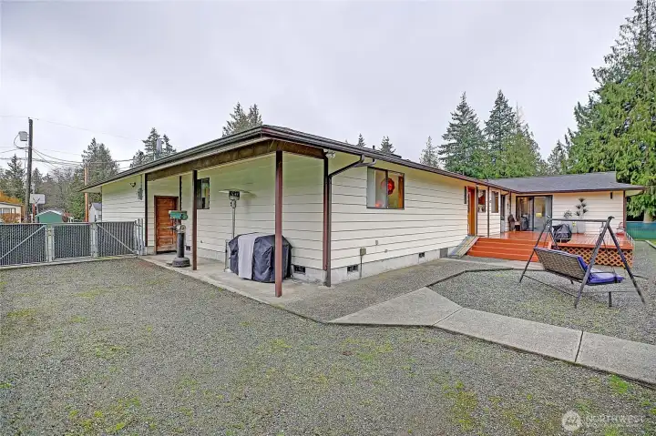 Plenty of room for an RV, plus a nice covered protected area off of garage..