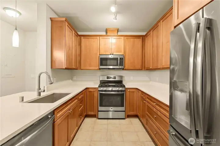Kitchen has granite countertops, gas oven with cooktop and stainless steel appliances