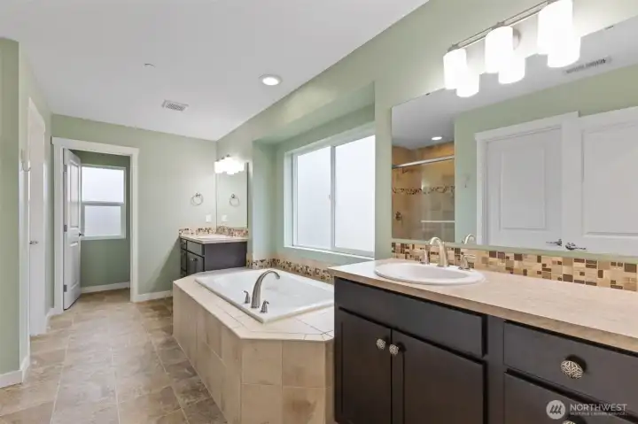 Primary suite with 2 vanities, large walk-in shower and soaking tub