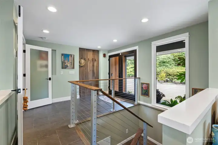 French doors and tile flooring decorate the entry. There is an abundance of can lighting throughout this home.    There are expansive view from almost every room.