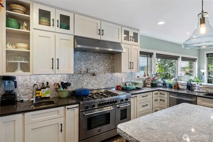 Granite backsplash, quartz countertops, a Bertazzoi gas 6-burner stove with double ovens, views to keep you happy, two dishwashers.....so much to love about this kitchen.