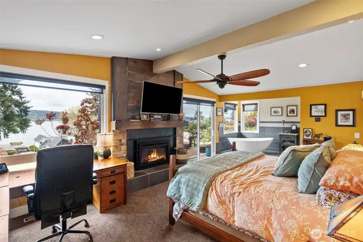 The primary suite also enjoys its own gas fireplace, gorgeous views, its own private deck, a vessel tub and expansive primary bathroom.