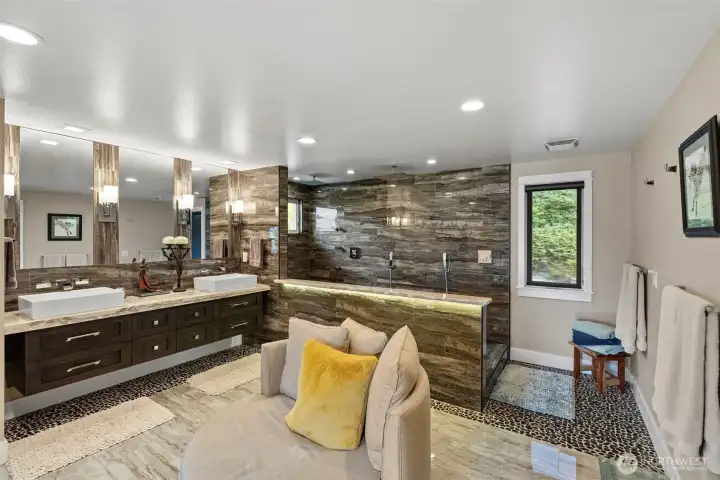 A bathroom to die for can be enjoyed in the primary suite, with beautiful tile flooring, granite countertops, and an expansive unique shower with mutilple heads and two rain showers. A large walk-in closet is just off to the right.