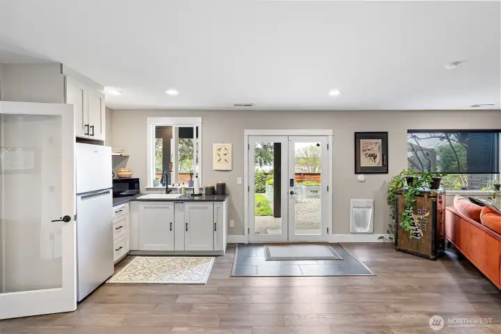 French doors to the lovely yard allow for easy access to the garden, green house, and lush vegetation discovered here. Beautiful flooring, too!