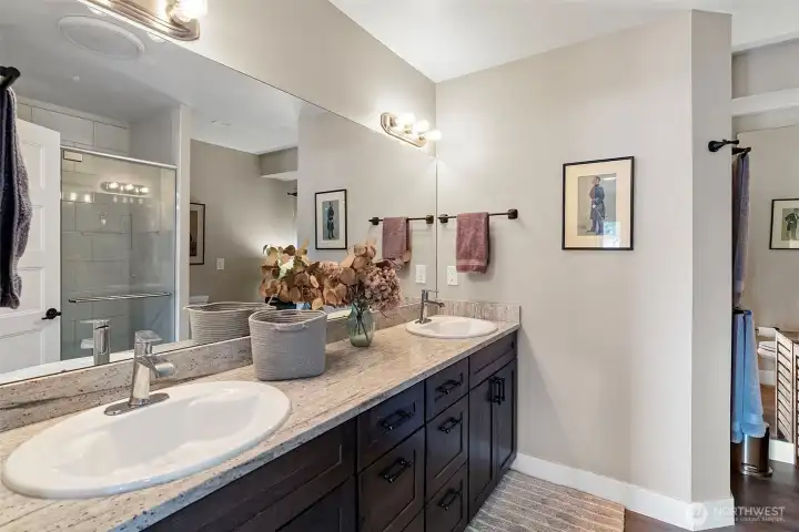 A 3/4 bath enjoys double sinks, a large shower, and beautiful countertops and flooring.