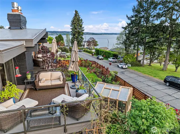 The primary bedroom private deck overlooks the beautiful, lush yard and marine views.