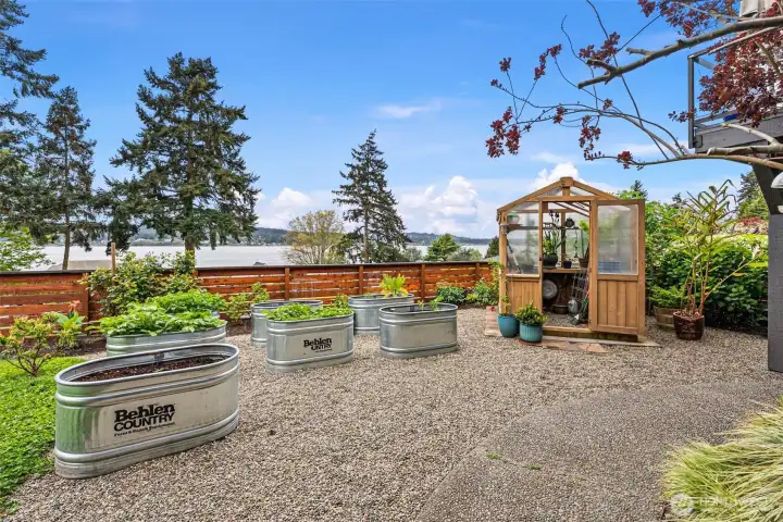 A gardener's delight, this home embraces plenty of space for digging in the dirt or growing your own starts in the lovely greenhouse.