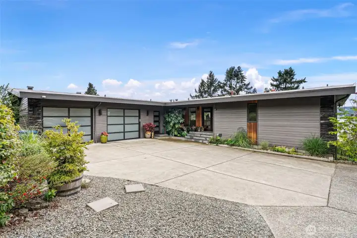 The garage doors have been reimagined with a more modern look.  There is plenty of parking for guests in your own private driveway.