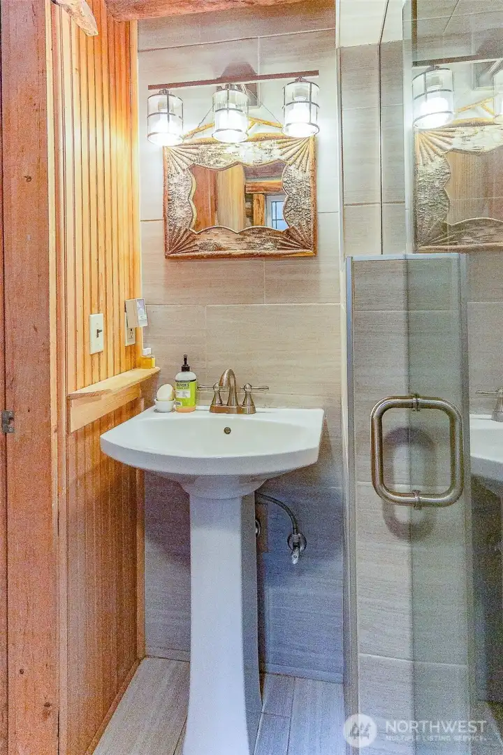The bathroom has a spacious shower.