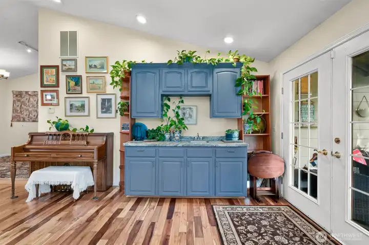 Entertaining is a snap with the conveniently located wet bar and deck access through the french doors.